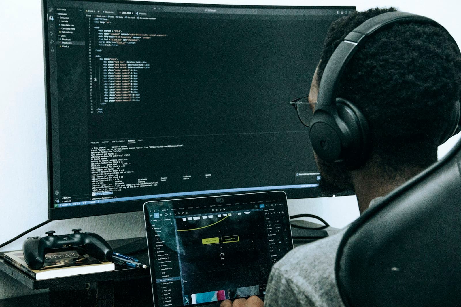 Developer writing code at a large monitor